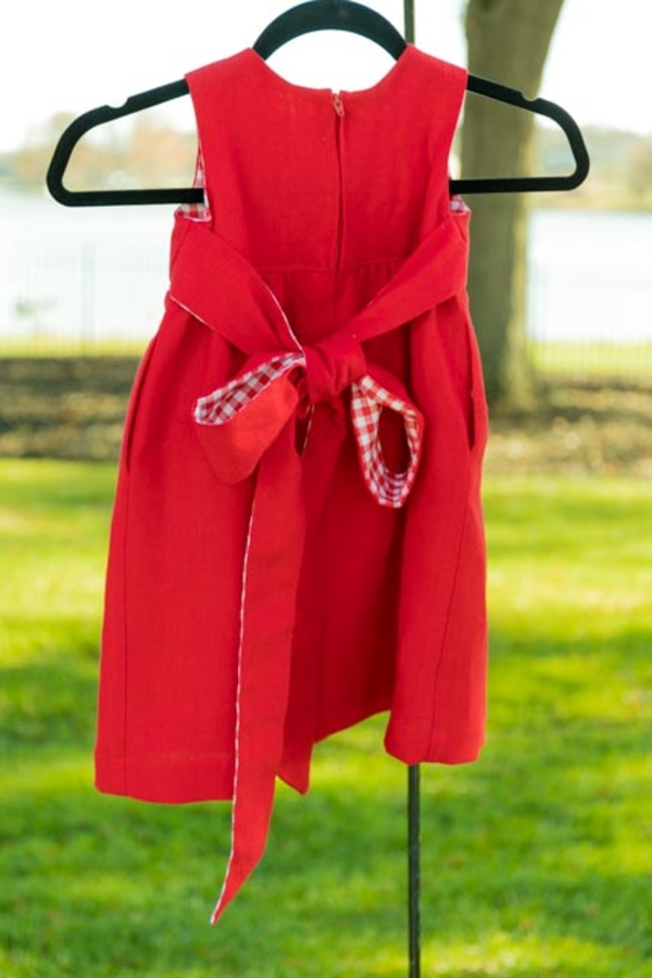 Gigi, This little girls dress is made from heavyweight linen, 4C22 Crimson.  I added the bow and side poc...