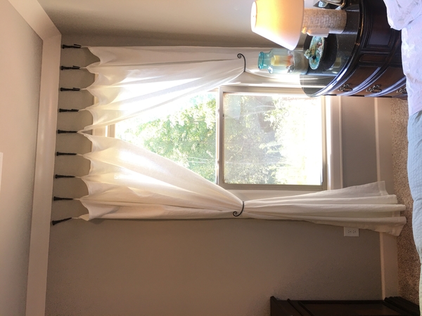Tracy, I made curtains with tab tops and used hooks from Hobby Lobby with forged iron tiebacks. Love this f...