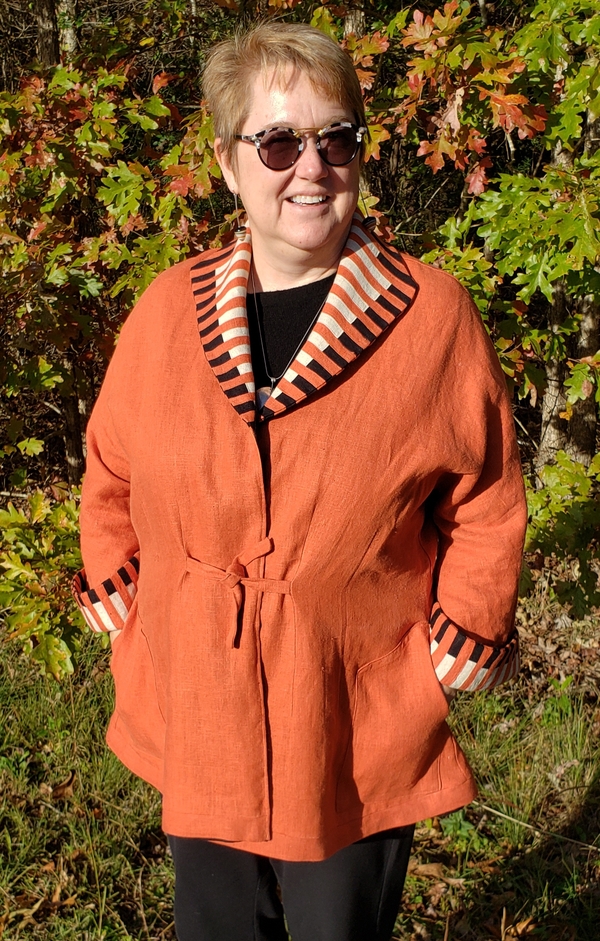 Julia, A reversible jacket, Mecca Orange one side, Black on opposite, pieced collar and cuffs. !920s theme...