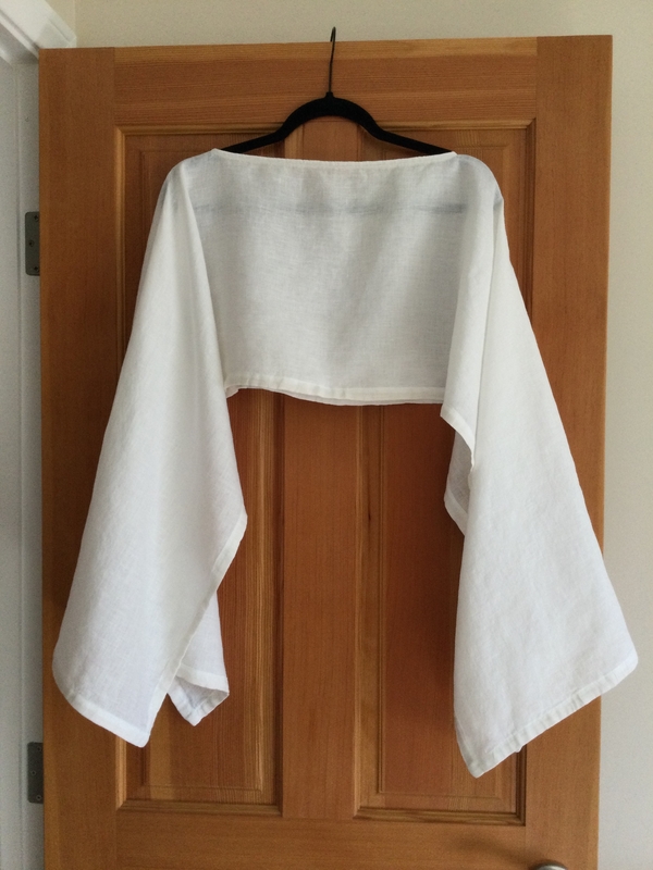 H, Shawl/poncho in bleached color.