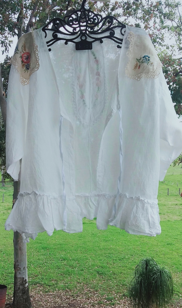 Michelle, A light cover up in bleached linen.
Ive decorated this with vintage doilys at the neckline, a tie f...