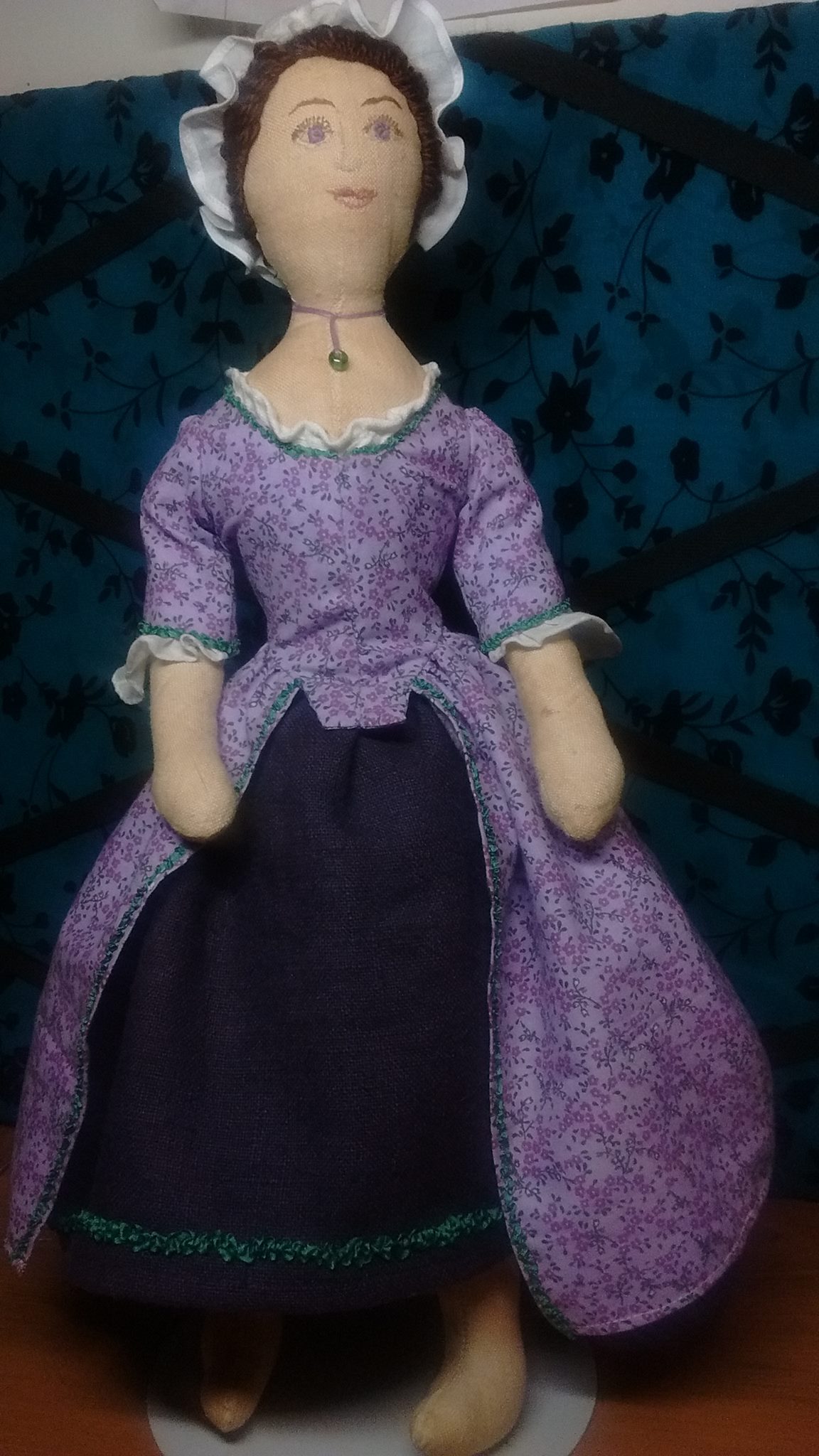 Hilary, This lavender lady is a 16 inch, 18th Century doll. Her body is tea dyed linen. Her face is hand emb...