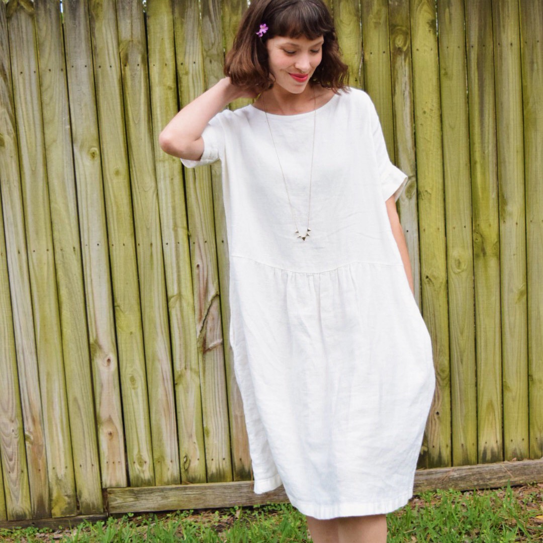 Randee, Gathered dress w inseam pockets and cuffed sleeves made with heavy weight bleached. 