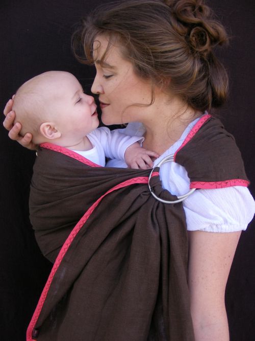 Rebecca, We love linen for baby slings - strong, natural, breathable. Edged with bias tape, this sling actual...