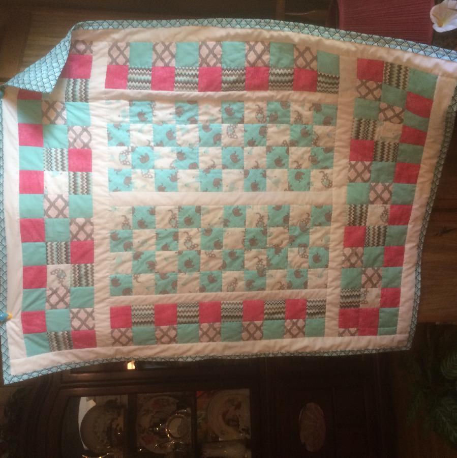 Krystal, throw cover size girls quilt for a special little girl finished it with in the ditch.