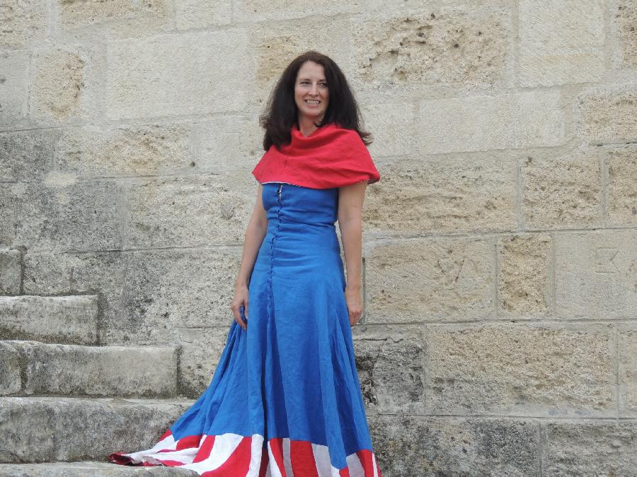 Toni, This dress was made from blue linen (6yds) with red and white linen stripes along the hem. I wore th...