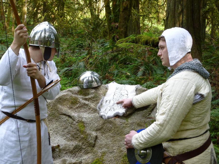 C storme, Reviewing the map.

Gambeson, under tunic, braies (not visible), arming cap (not visible), and linin...