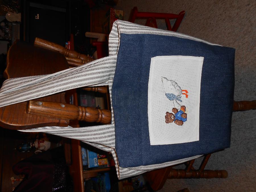 Gaye, Baby bag done in denim with pockets, magnetic closure, and cross stitch applique. The cross stitch w...