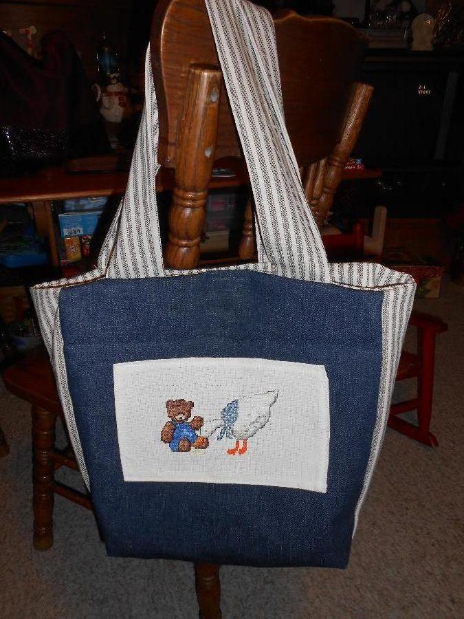 Gaye, Baby bag done in denim with pockets, magnetic closure, and cross stitch applique. The cross stitch w...
