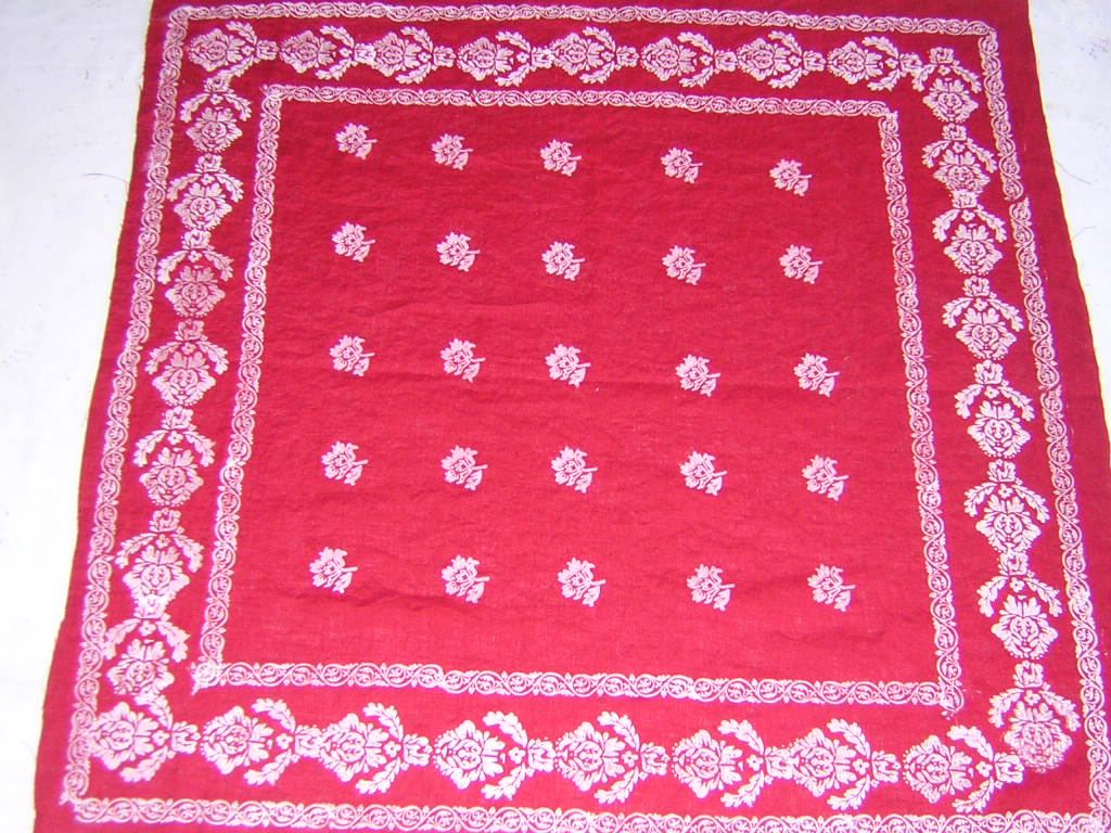 Laura, This is a red medium weight linen cut into a 34 x 34 scarf and hand printed in a white design. The...