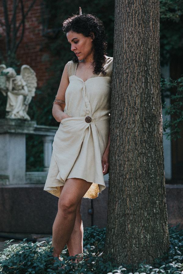 Mandi, 100% linen Roman Draped Mini Dress, featuring a folded asymmetrical front seam and hidden triangle p...