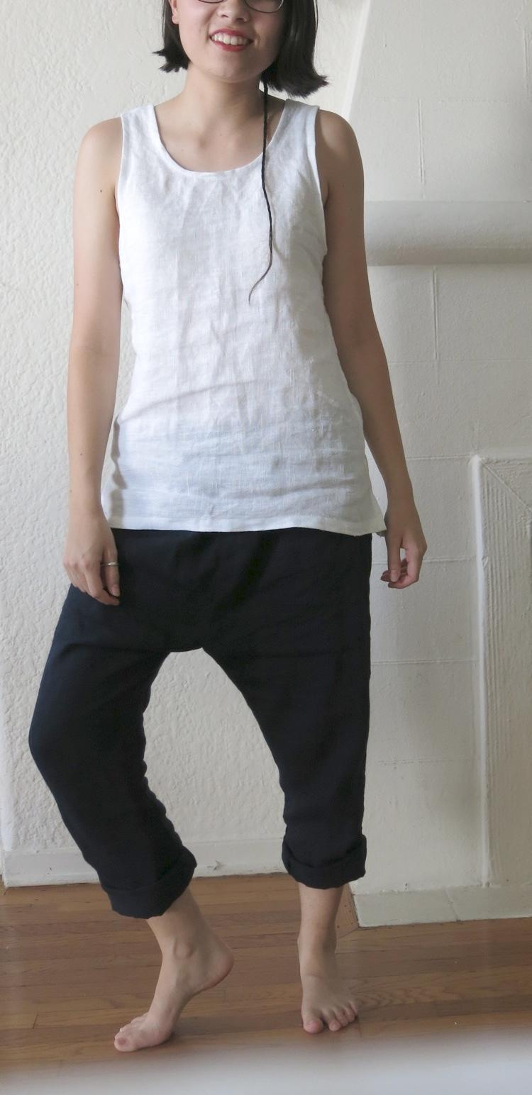 Anna, A tank top in IL019 Bleached, and a pair of drop-crotch elastic-waist pants with rolled cuffs in IL0...
