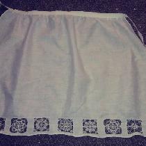 Christa, Linen apron with reticella lace motifs b...