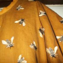 Close up of bee mesh overlay over autumn gold lightweight linen