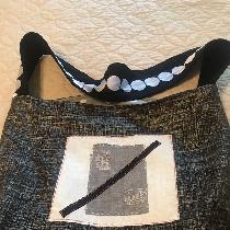 A tote bag out of linen. Lined in cotton. Fused collage on front. Strap is linen with a trim att...