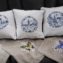 Patricia, Various embroidered cushion covers on he...