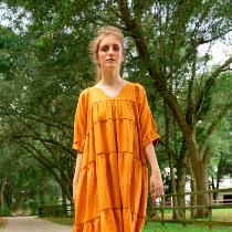 Maxi length dress with v-neck, 3/4 sleeves and tiered panels.