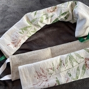 Sleeves for rice filled neck warmers are hand printed from pressed botanicals on bleached linen,...