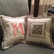 Embroidered pillows.  Who needs fringe when you have nice heavy linen that you can fringe yourse...