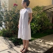 A tier midi dress with puff short sleeves. There are pockets in both sides and a back neck keyho...