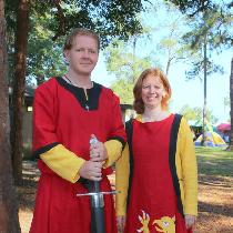 12th century Germanic paired tunics for him and a 13th century sideless surcoat with griffin app...