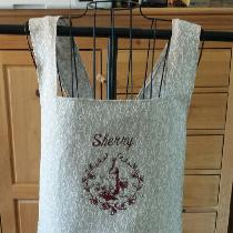 This apron was made from the floral twig linen, personalized with my client's design of choice a...