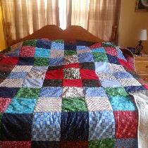 I made a Christmas quilt for my grandson who is always hot with Christmas squares on the front a...