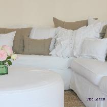 Collection of linen pillows in various sizes and design details. Simple color palette of natural...