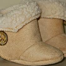 Cozy infant booties made of faux suede/sheepskin fabric with Velcro closures
