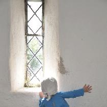 Peeking out the window of an old castle in Ireland, this little lass is wearing a blue linen tun...